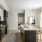 Model kitchen at our 55 and over apartments in Farmington, featuring stainless steel appliances and a kitchen island.