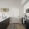 Model kitchen at our 55 and over apartments in Farmington, featuring stainless steel appliances and a kitchen island.