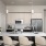 Model kitchen at our 55 and over apartments in Farmington, featuring stainless steel appliances and a kitchen island.