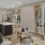 Model living room at our senior living community in Farmington, UT, featuring large windows and doors to the balcony.