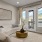 Model living room at our senior living community in Farmington, UT, featuring large windows and doors to the balcony.