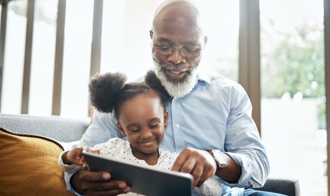 Grandfather reading a book to his grandchild